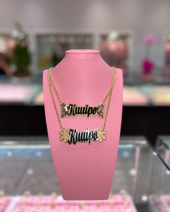 Custom Kuuipo name pendants in gold — enamel script with butterfly and flower accents