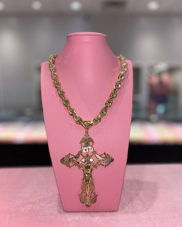 Gold crucifix pendant on a thick rope chain